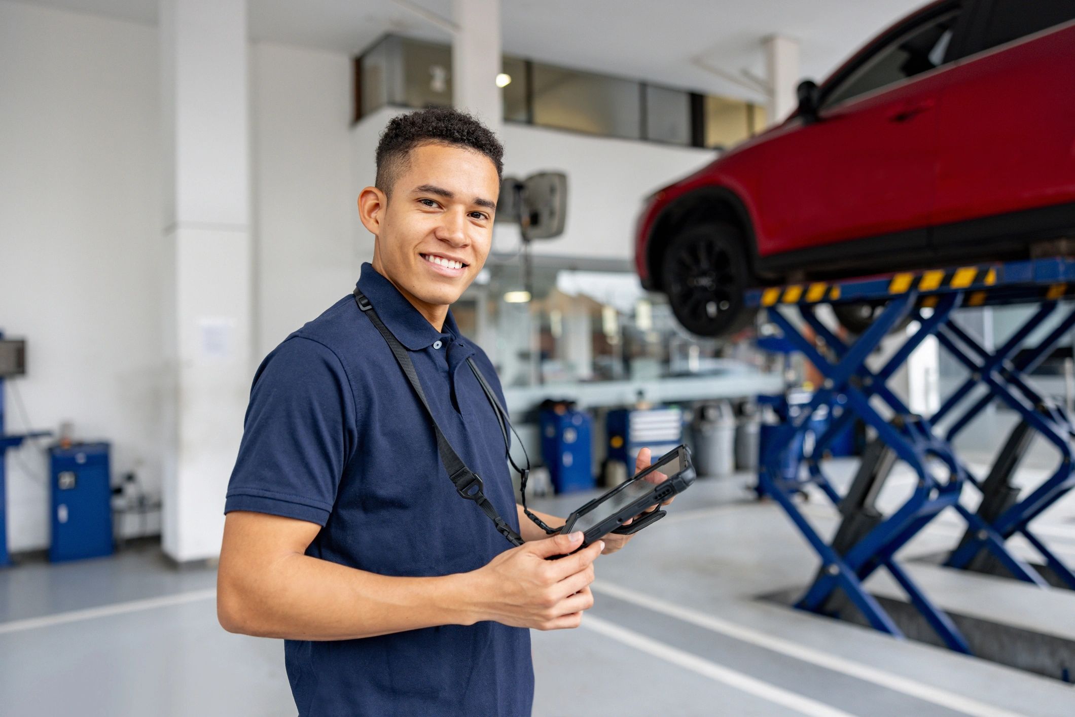 Service advisor holding a tablet in an auto shop