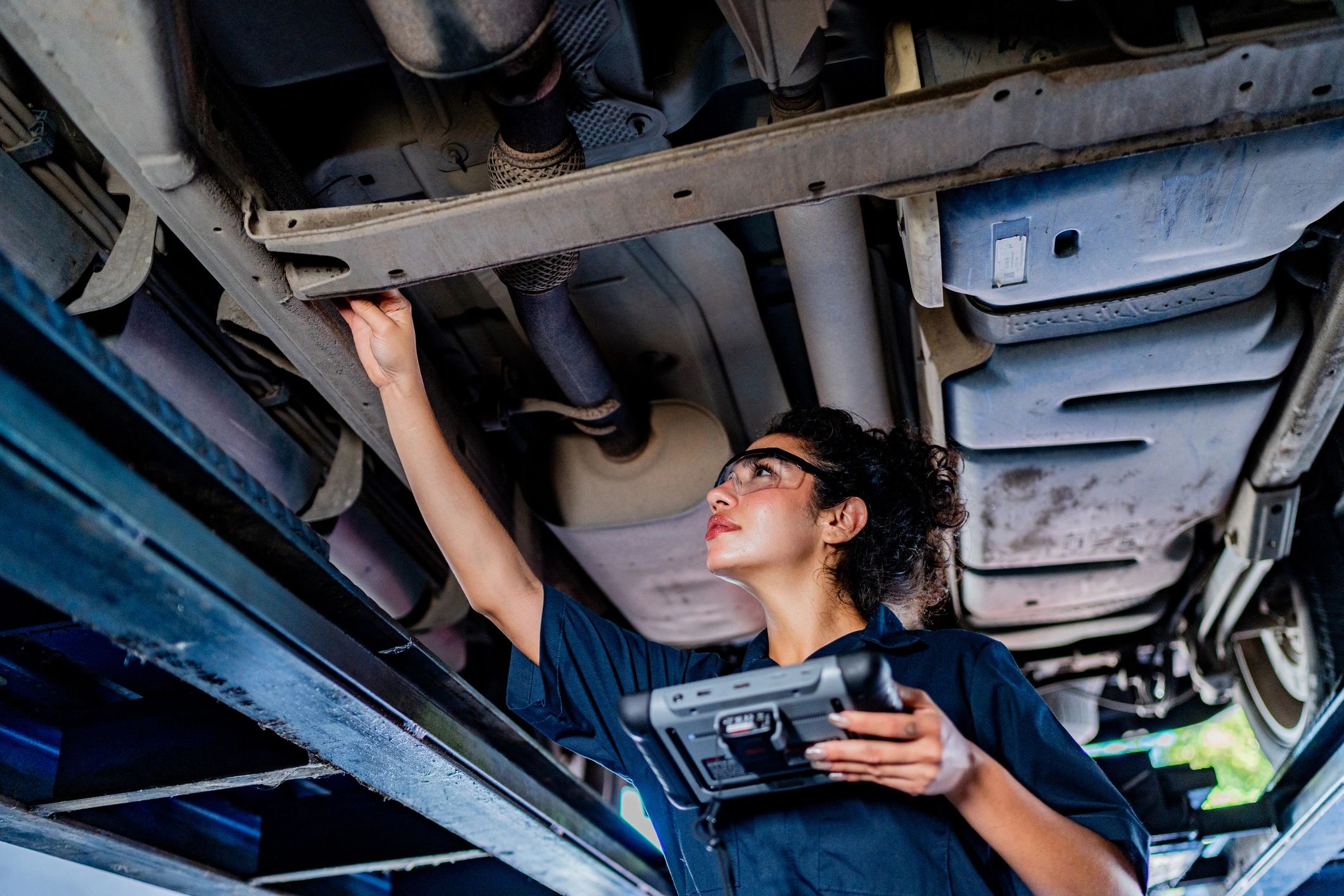 Mechanic inspecting a vehicle at an auto repair shop